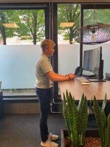 jongen staat achter sta bureau