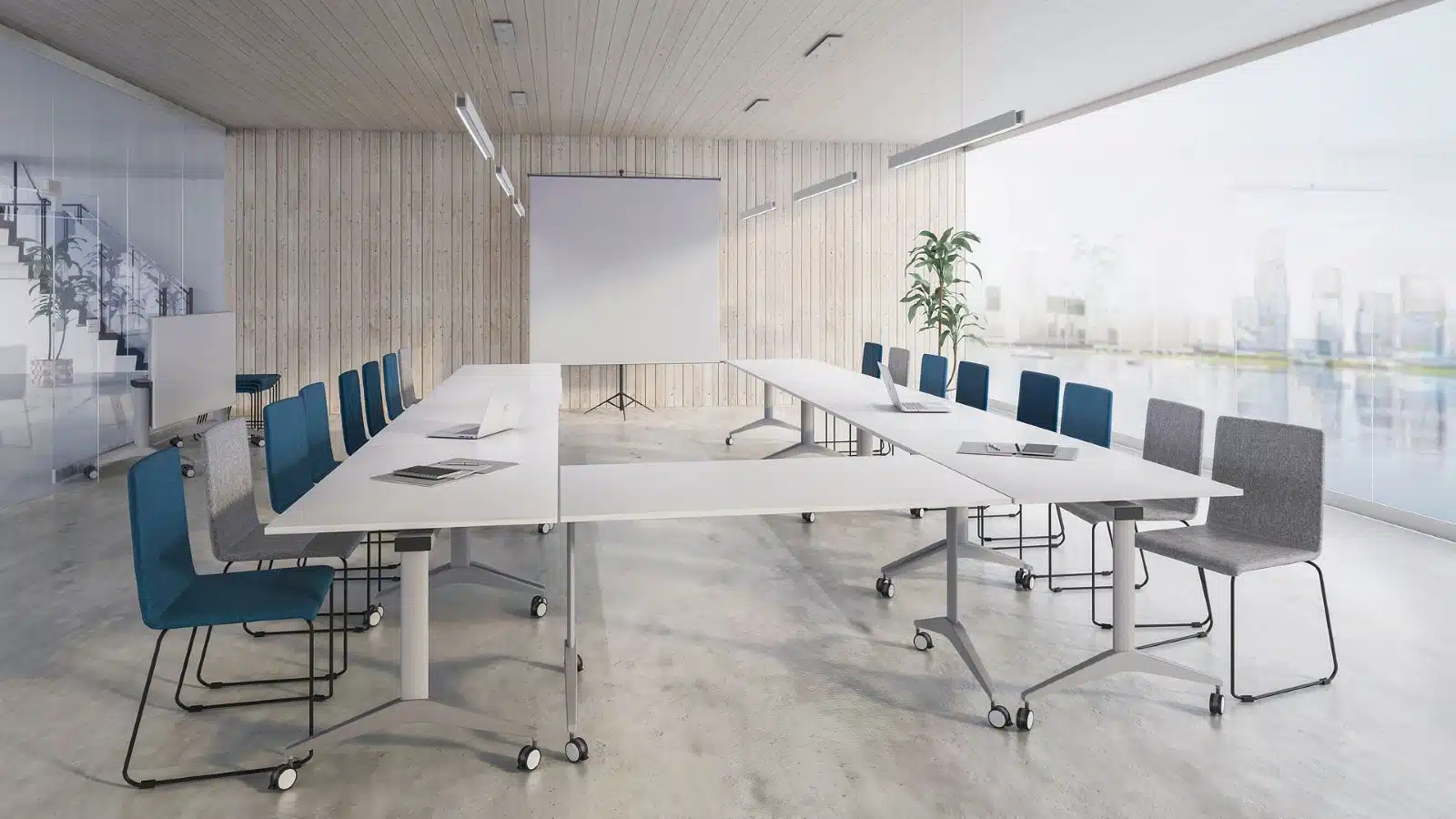 witte klaptafels in u-opstelling met grijze en blauwe stoelen met buisframe